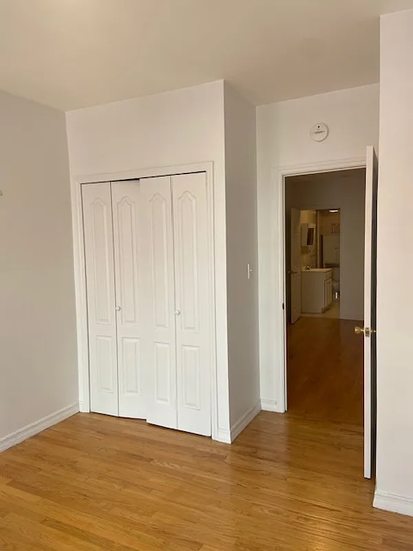 178 Ludlow Street, Unit 3A Manhattan, NY 10002 - Photo 4 of 7 a view of an empty room with wooden floor