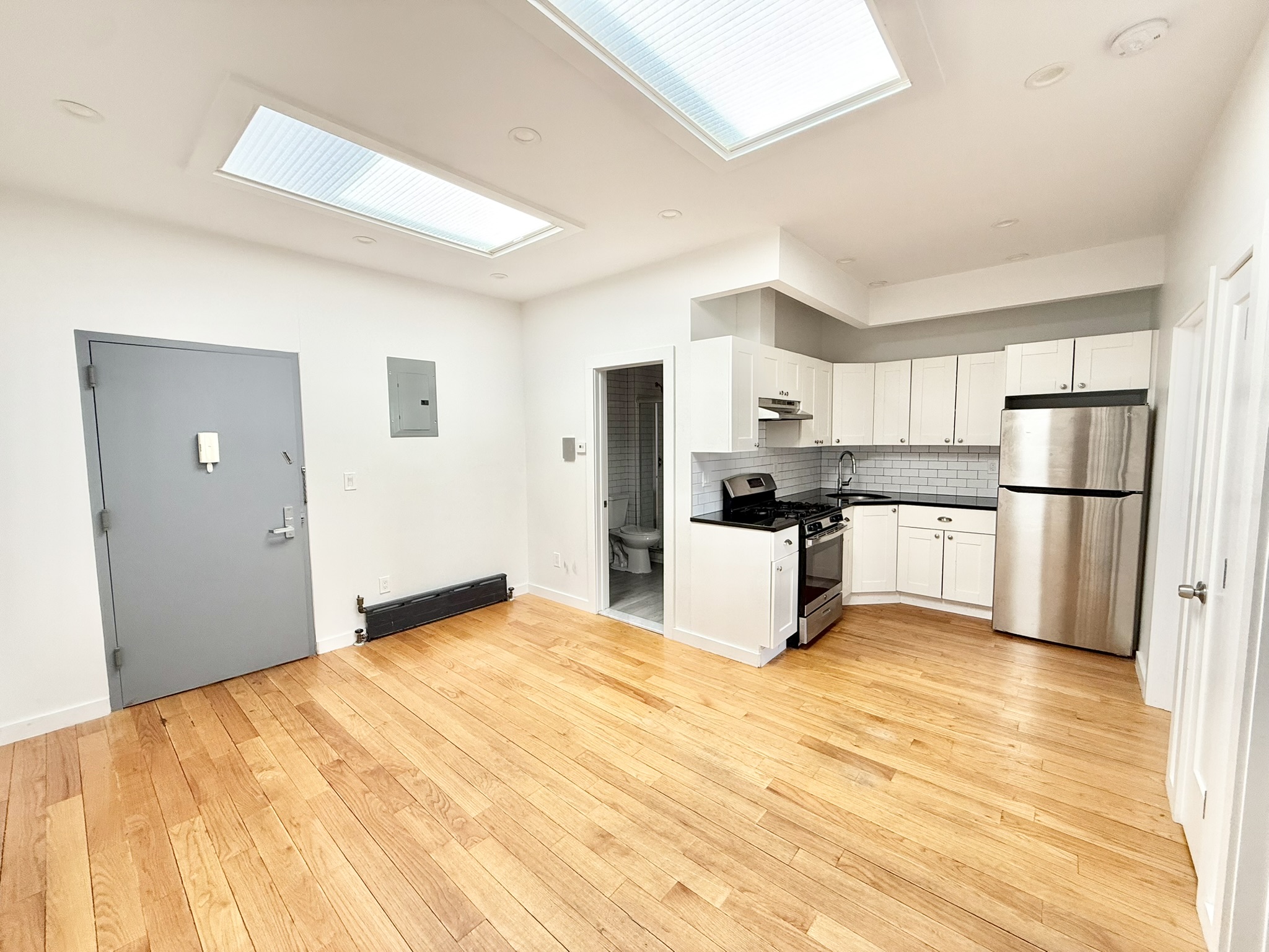 2013 Flatbush Avenue, Unit 2R Brooklyn, NY 11234 - Photo 11 of 11 a kitchen with stainless steel appliances a refrigerator and white cabinets