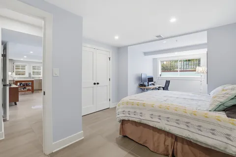 a bedroom with a bed and a mirror