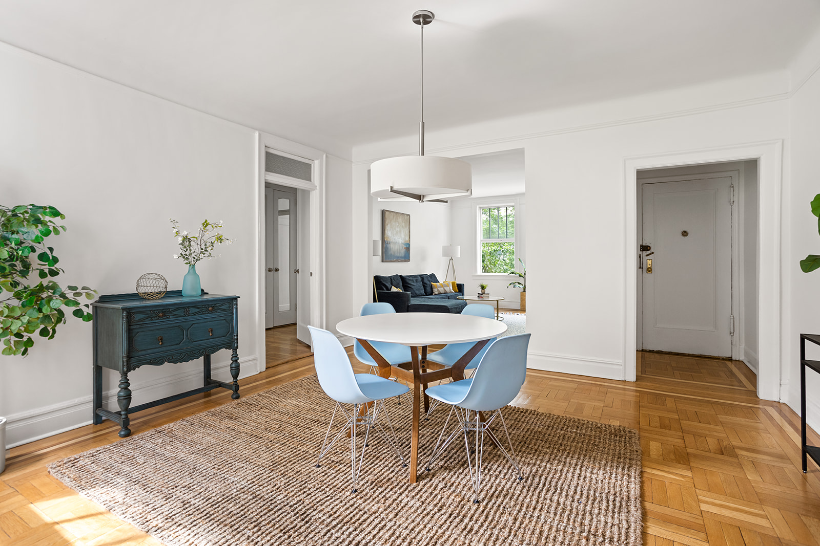 35-47 80th Street, Unit 2 Queens, NY 11372 - Photo 3 of 12 a dining room with furniture a rug and a chandelier