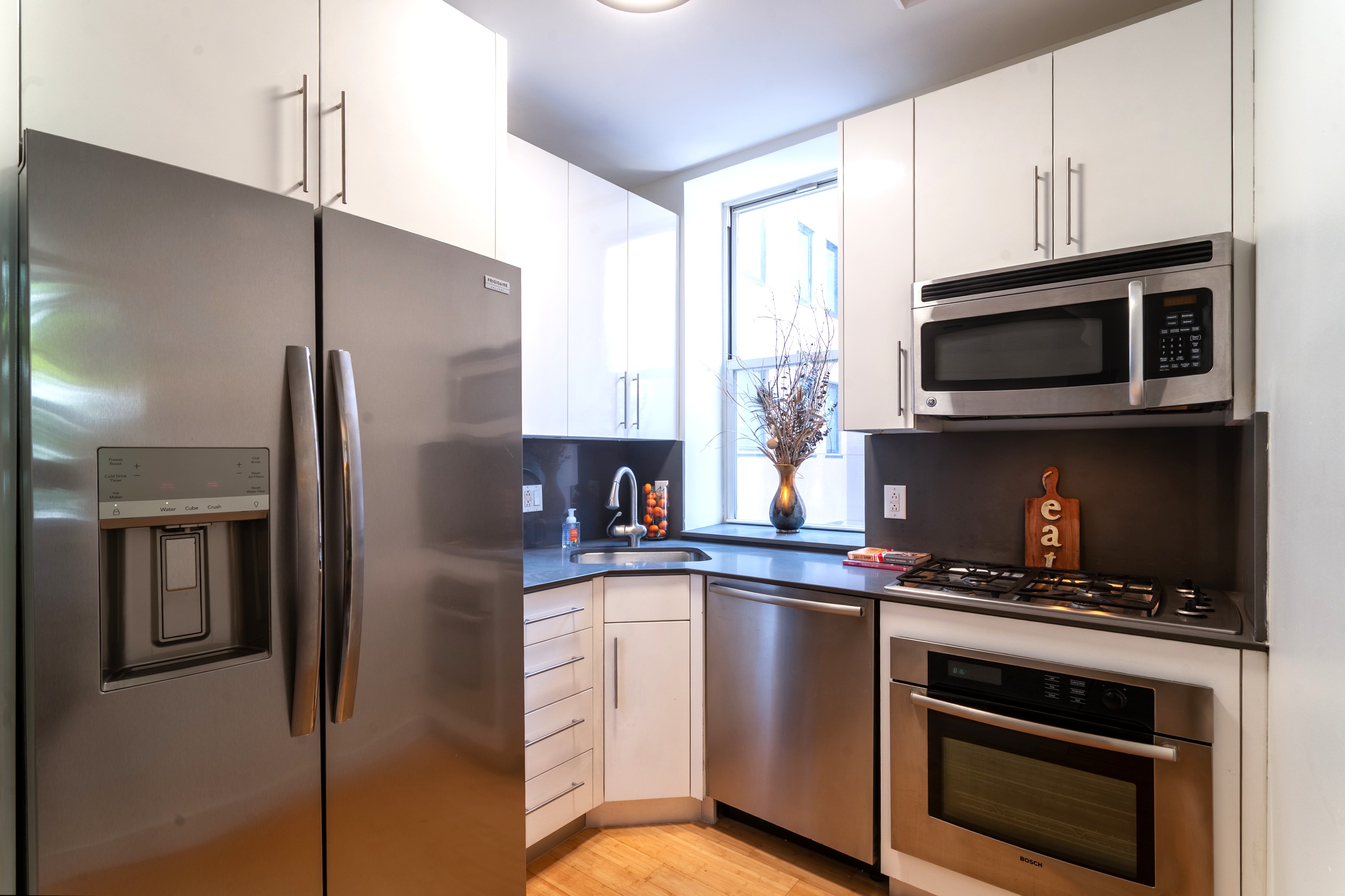 479 West 152nd Street, Unit 4C Manhattan, NY 10031 - Photo 4 of 23 a kitchen with stainless steel appliances a refrigerator stove and microwave