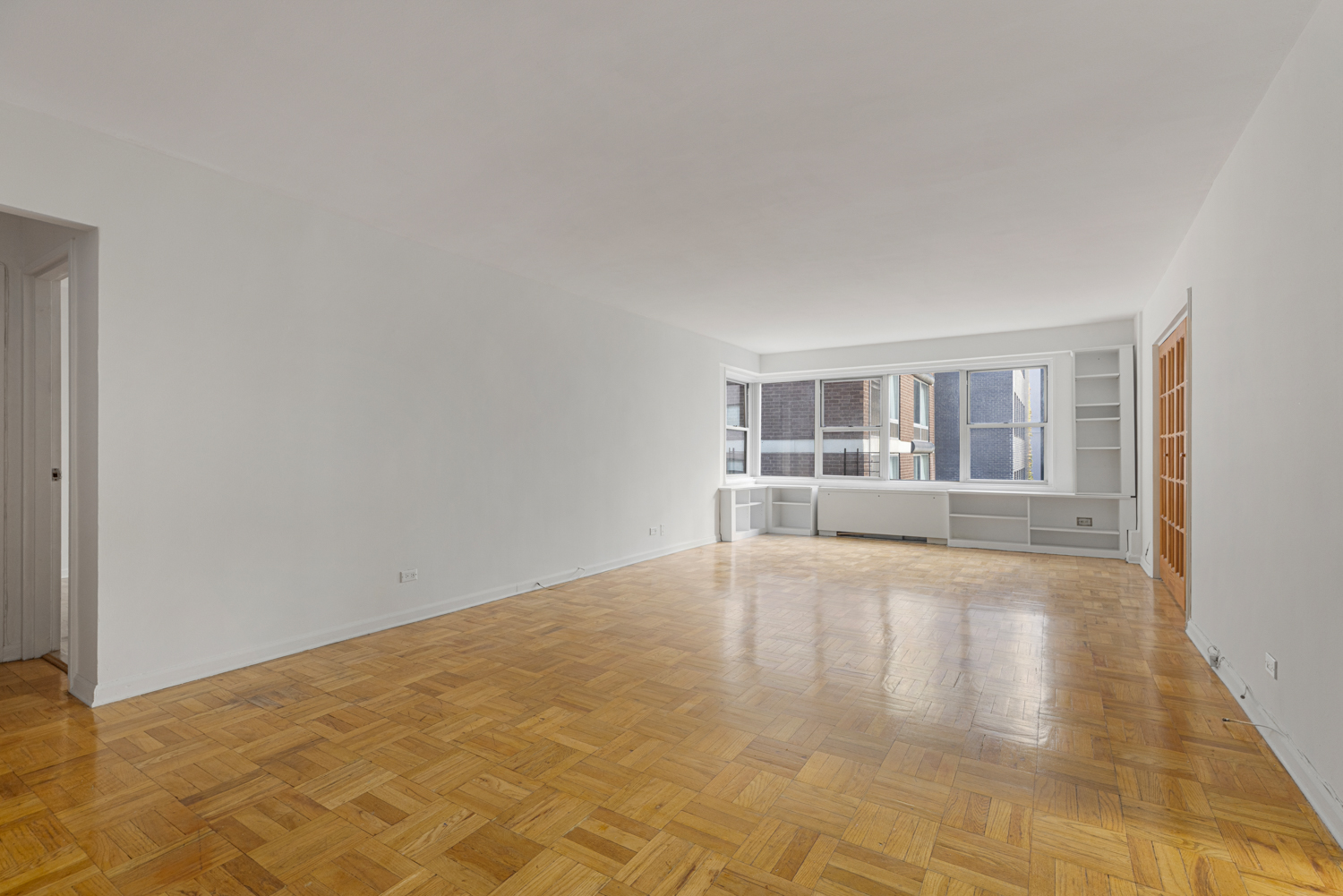 136 East 56th Street, Unit 9J Manhattan, NY 10022 - Photo 7 of 14 a view of an empty room with a window