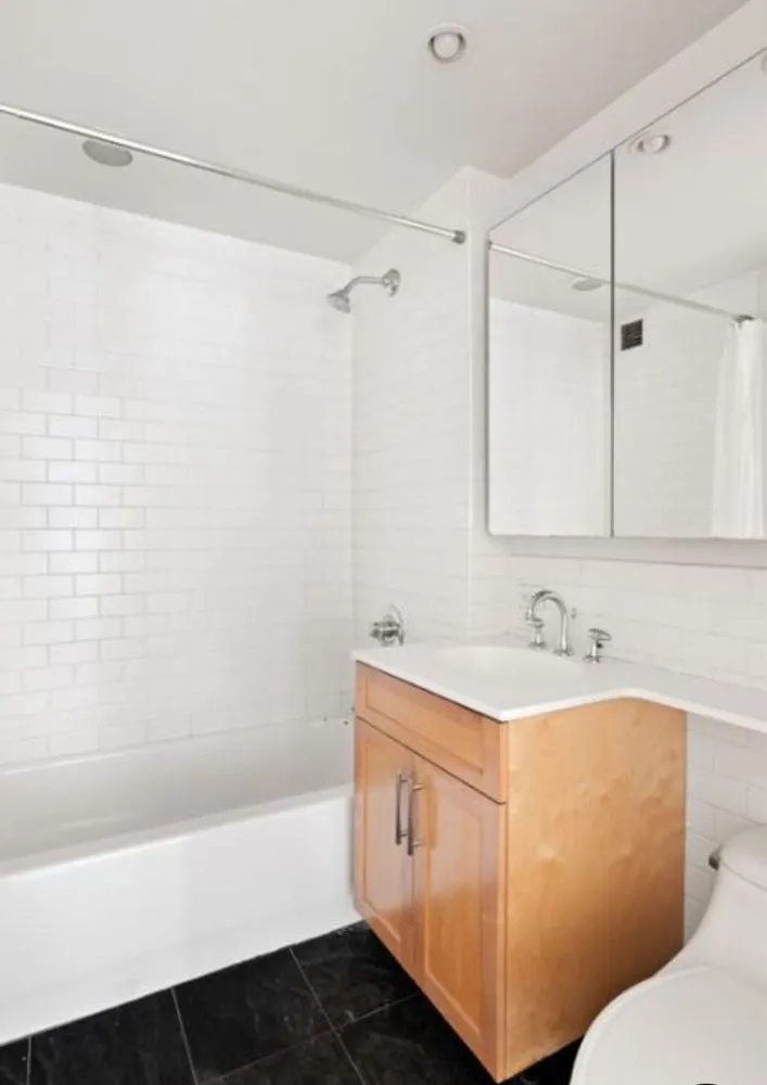 a bathroom with a sink a toilet and a bathtub
