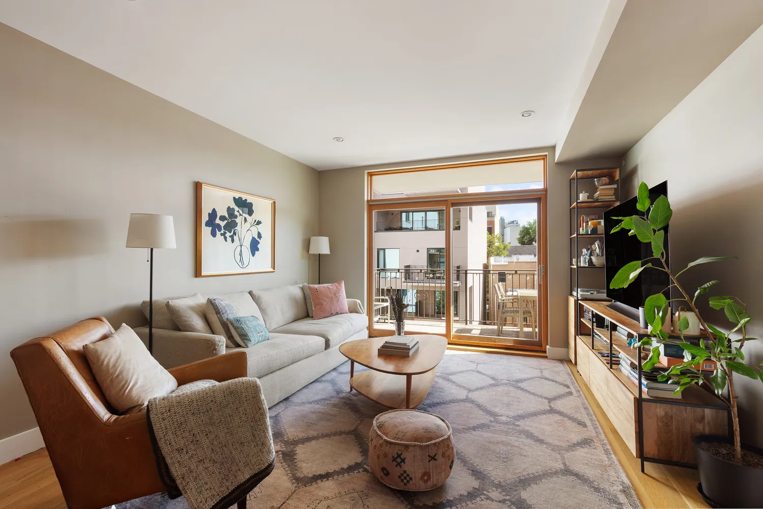 a living room with furniture and a floor to ceiling window