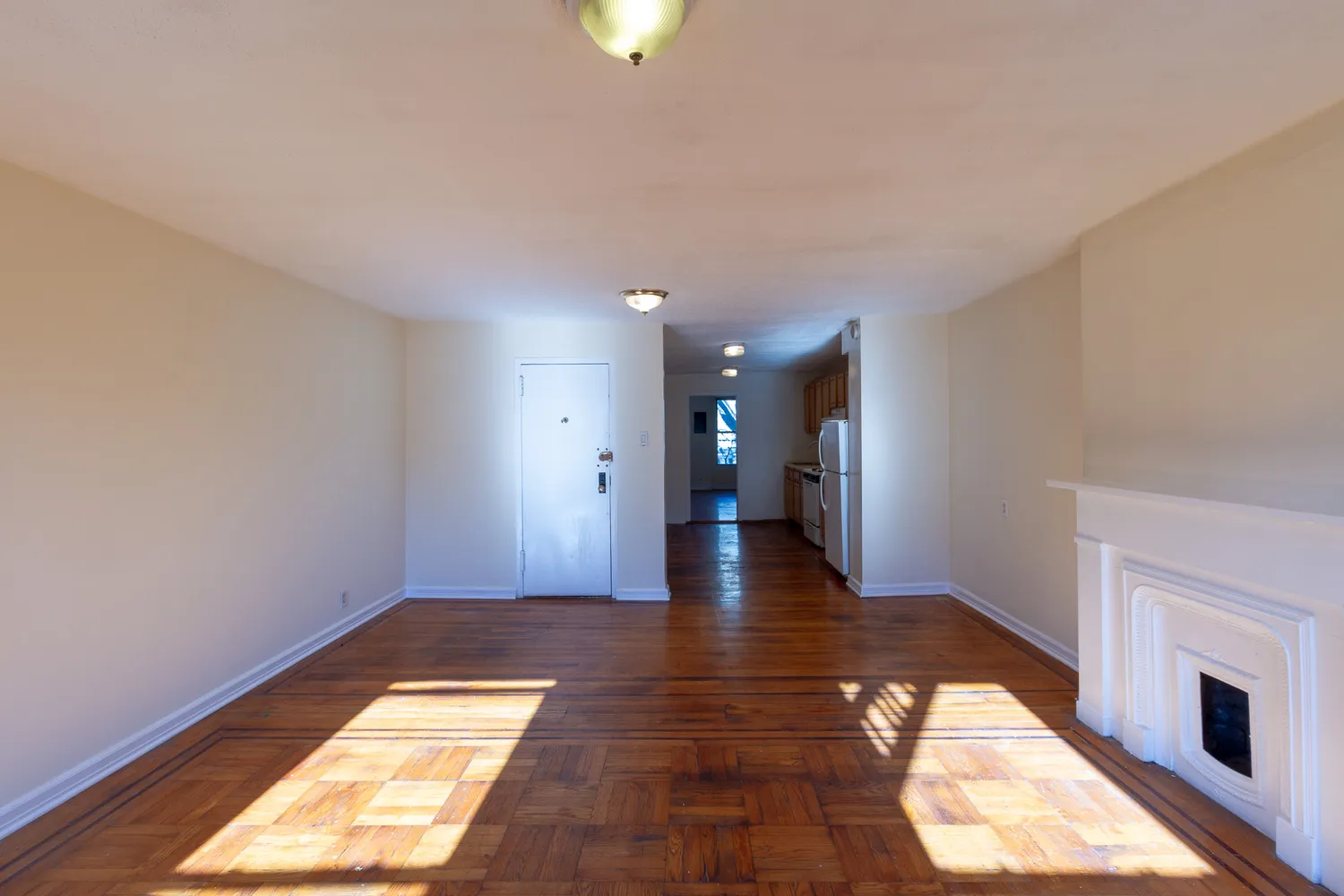 a view of a hallway with wooden floor and a fireplace