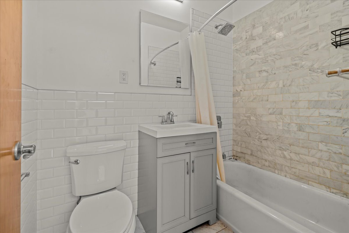 1773 Nostrand Avenue Brooklyn, NY 11226 - Photo 7 of 10 a bathroom with a sink toilet and vanity