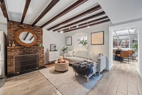 a spacious bedroom with a bed and a chandelier