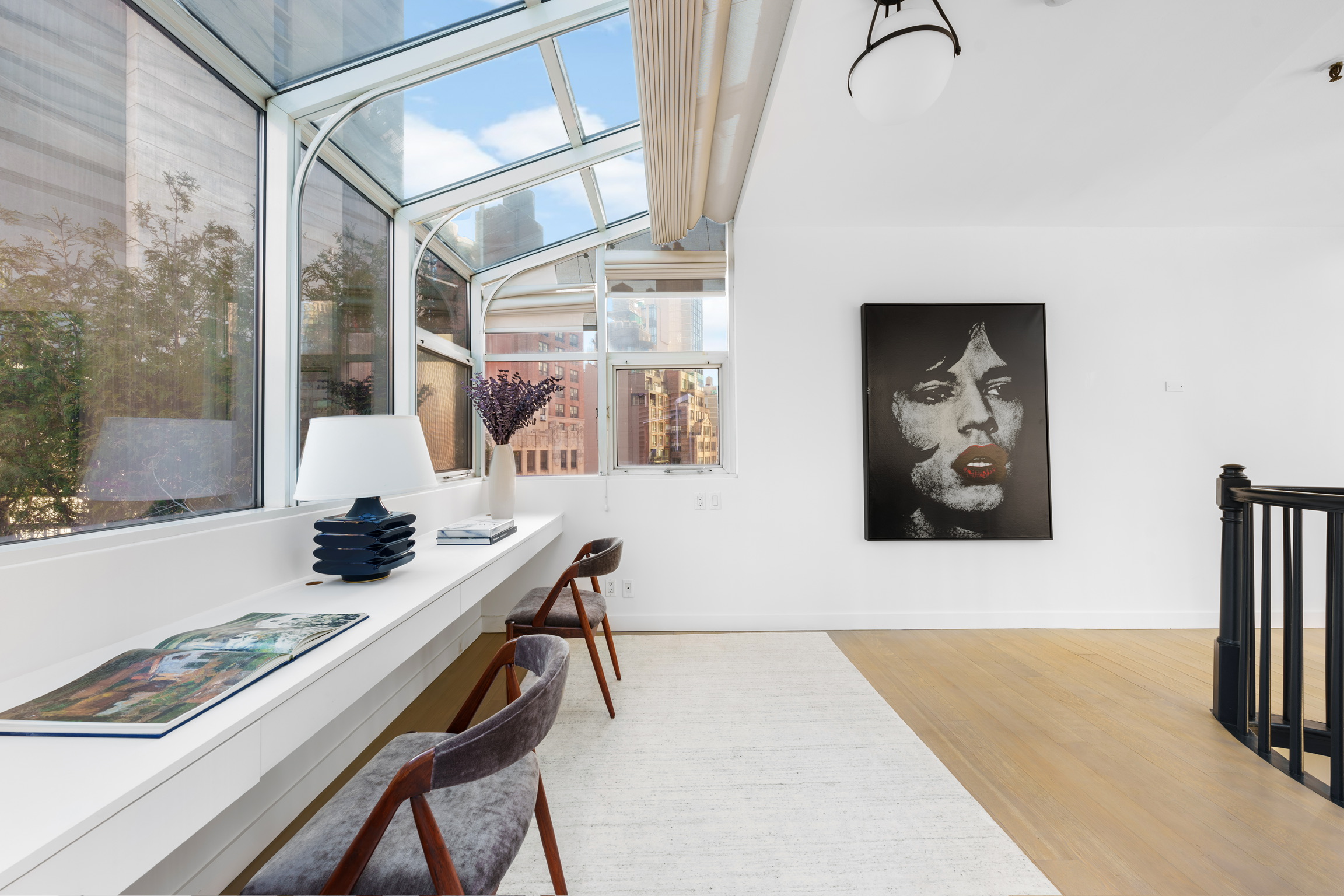 1200 Broadway, Unit PH89 Manhattan, NY 10001 - Photo 40 of 47 a view of a workspace with furniture and floor to ceiling window