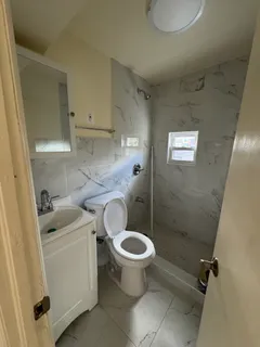 a bathroom with a sink toilet and a mirror