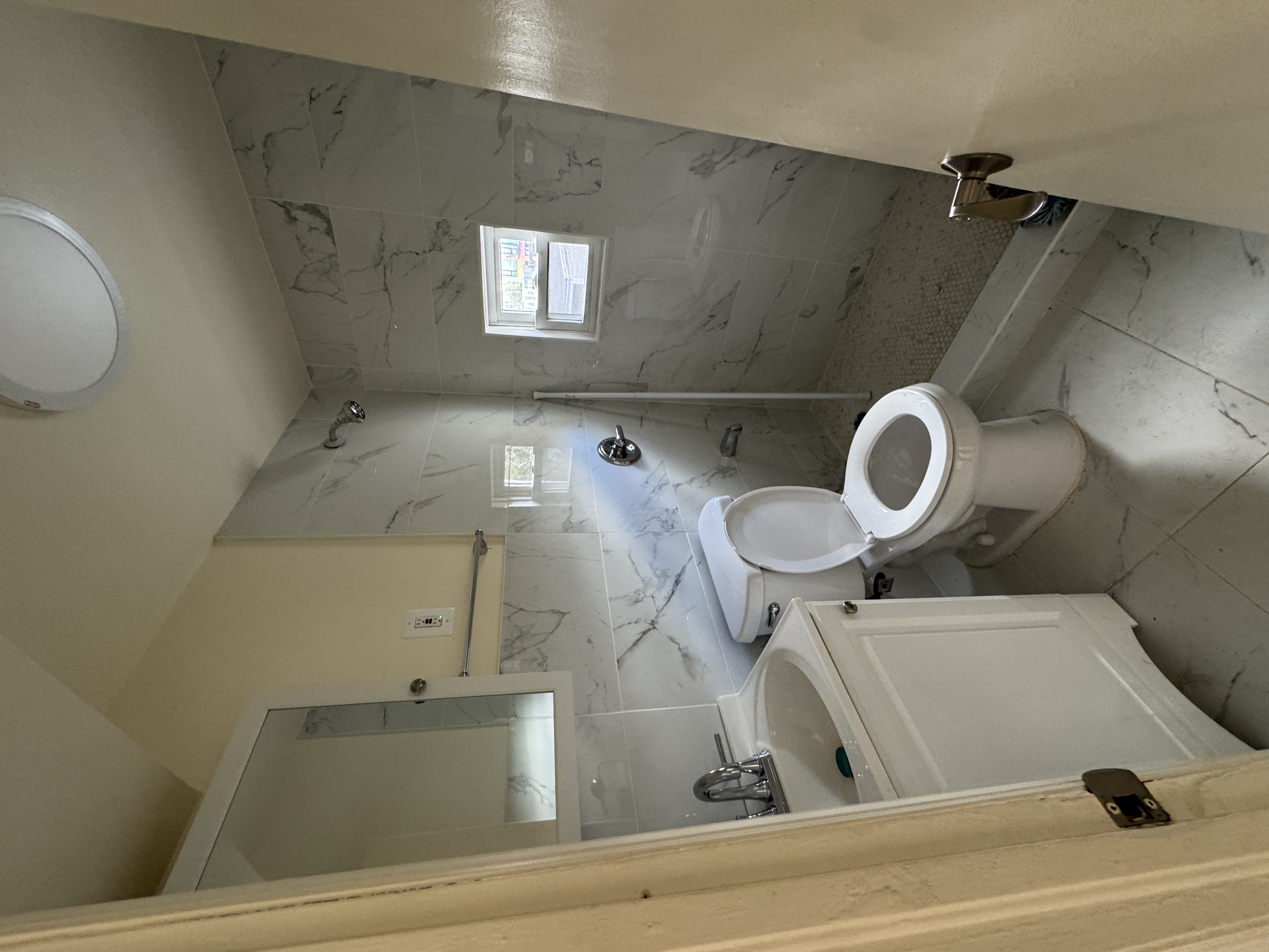 1333 Bristow Street Bronx, NY 10459 - Photo 3 of 6 a bathroom with a sink toilet and a mirror