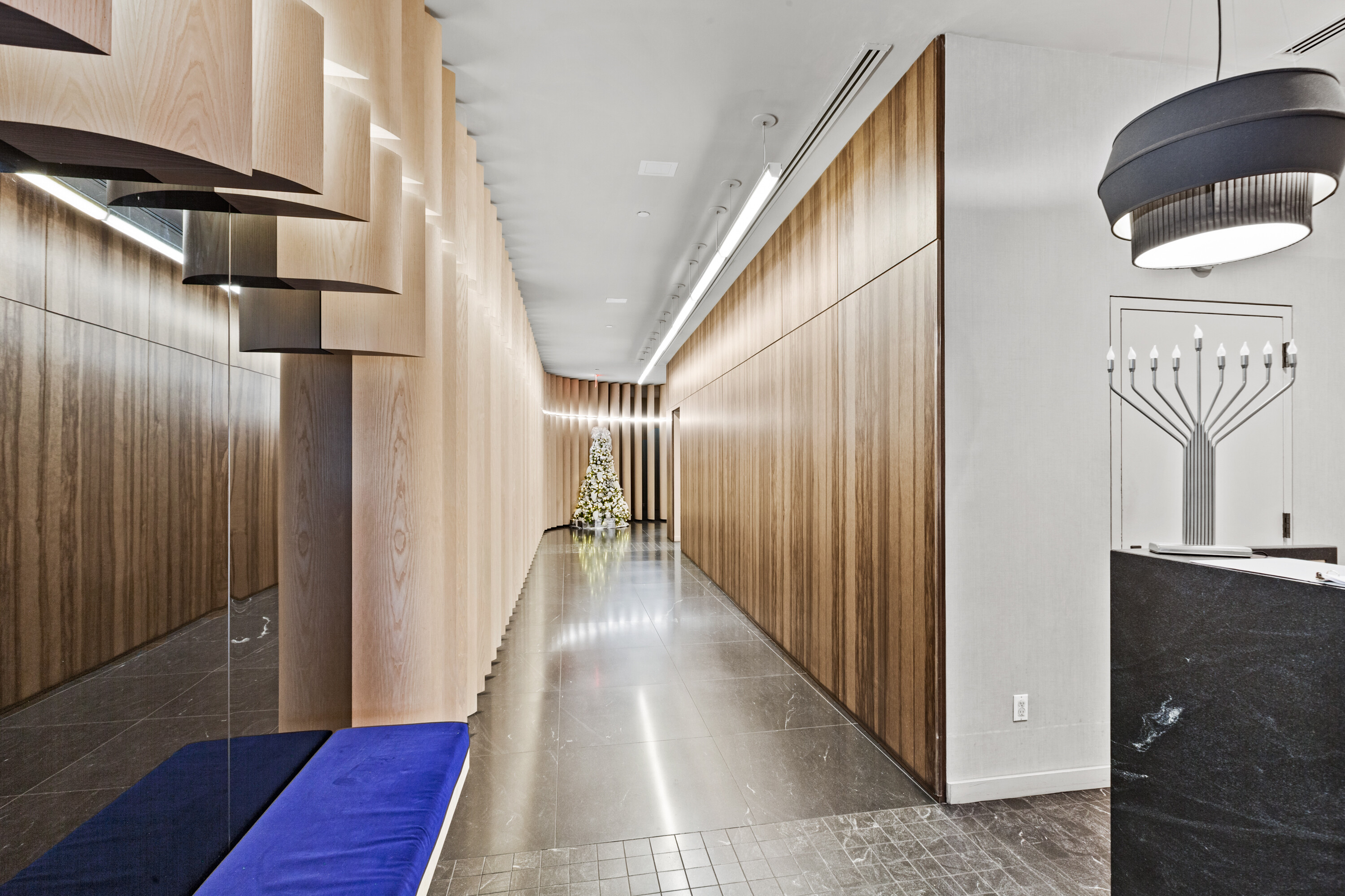 385 1st Avenue, Unit 20B Manhattan, NY 10010 - Photo 9 of 10 a view of a hallway with wooden floor and staircase