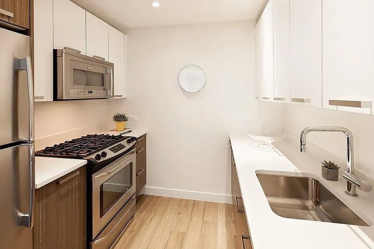 26-14 Jackson Avenue, Unit PHD Queens, NY 11101 - Photo 2 of 11 a kitchen with granite countertop a stove and a sink