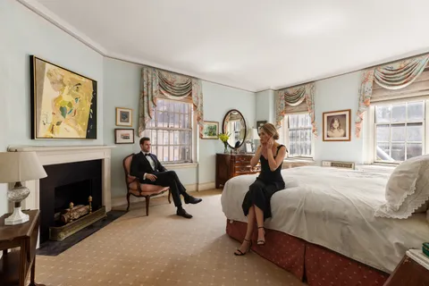 a bed room with a bed and a chair