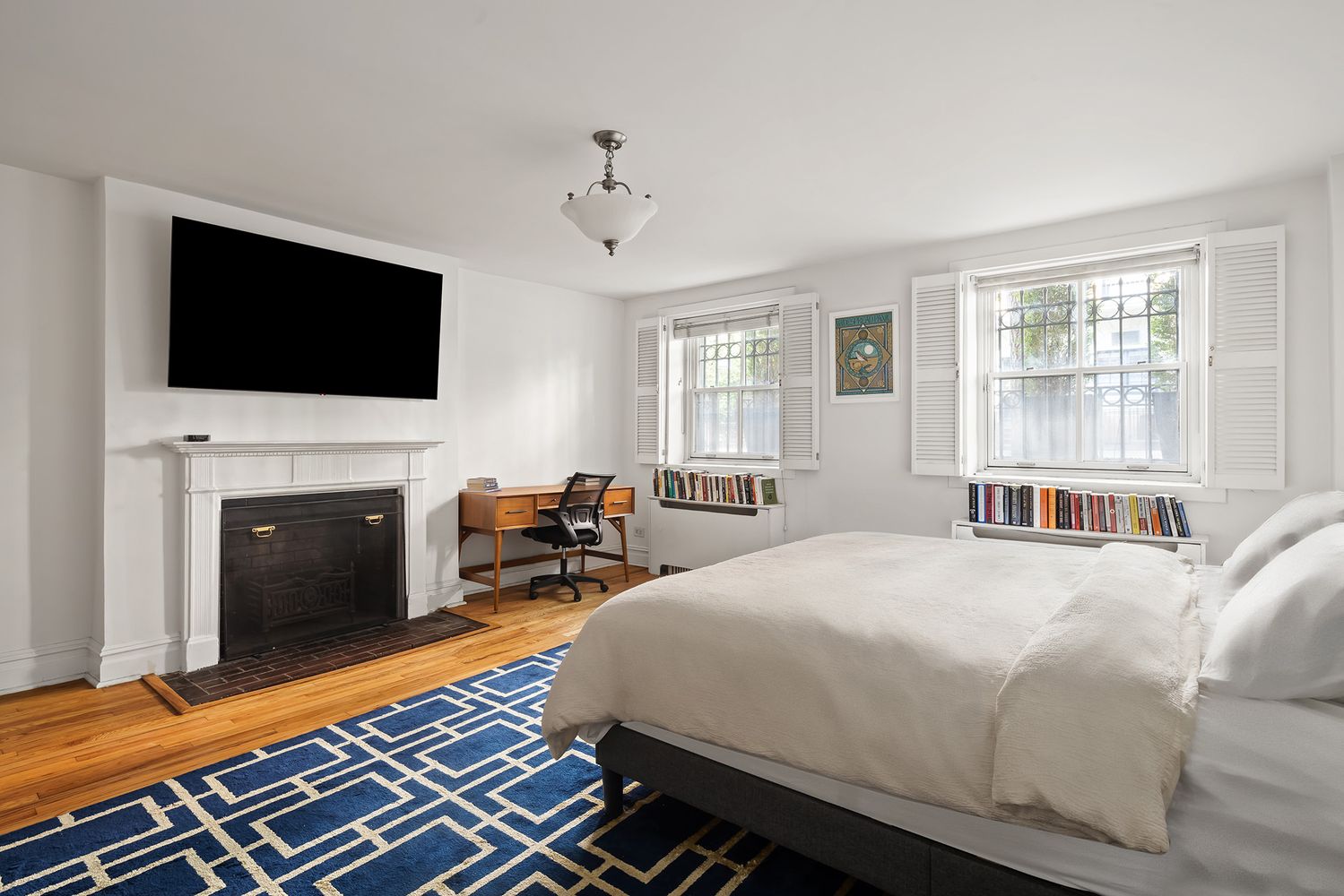 20 West 9th Street, Unit DUPLEX Manhattan, NY 10011 - Photo 7 of 10 a bedroom with a bed and a flat screen tv