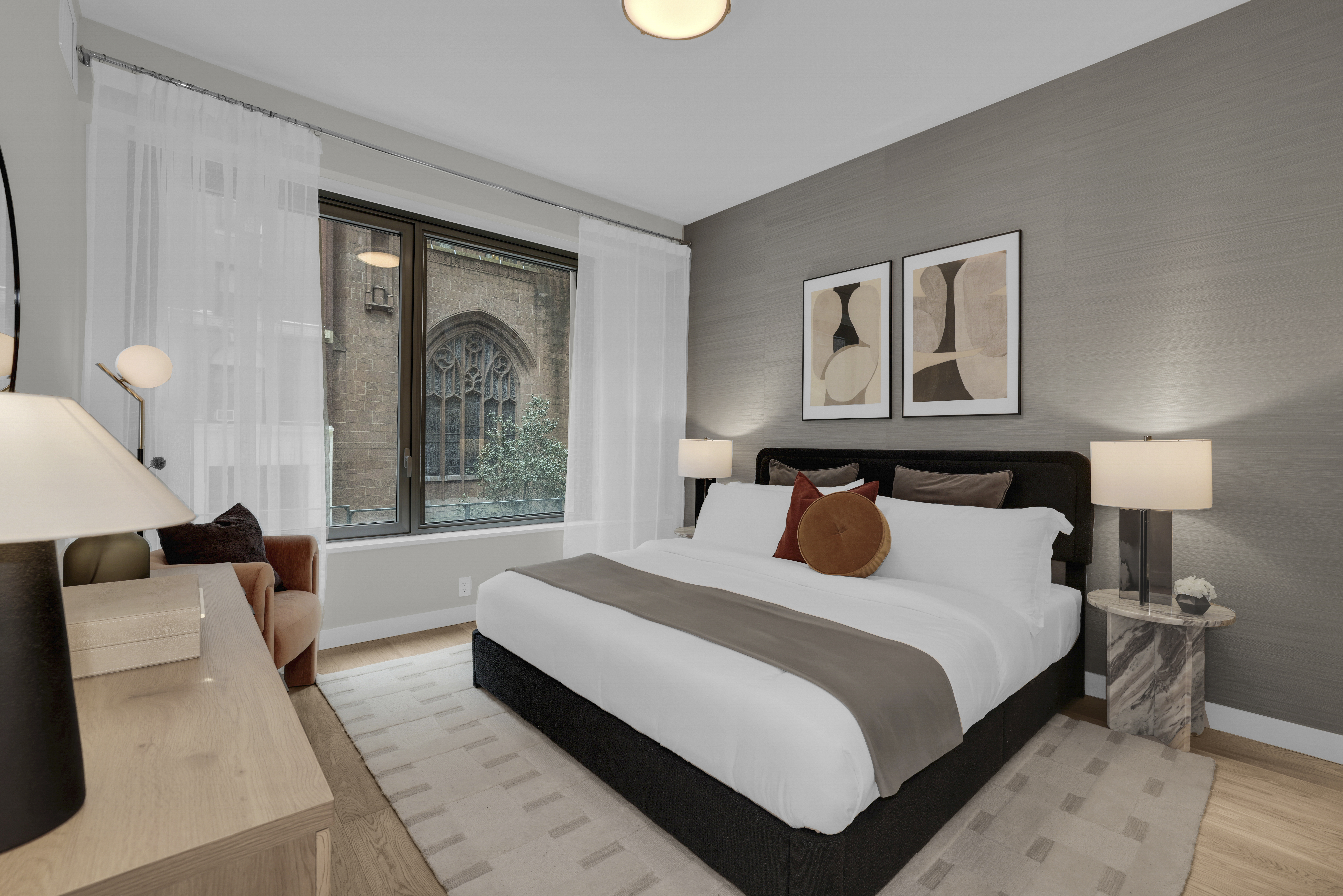 18 West 55th Street, Unit 15A Manhattan, NY 10019 - Photo 2 of 9 a bedroom with a large bed and a window