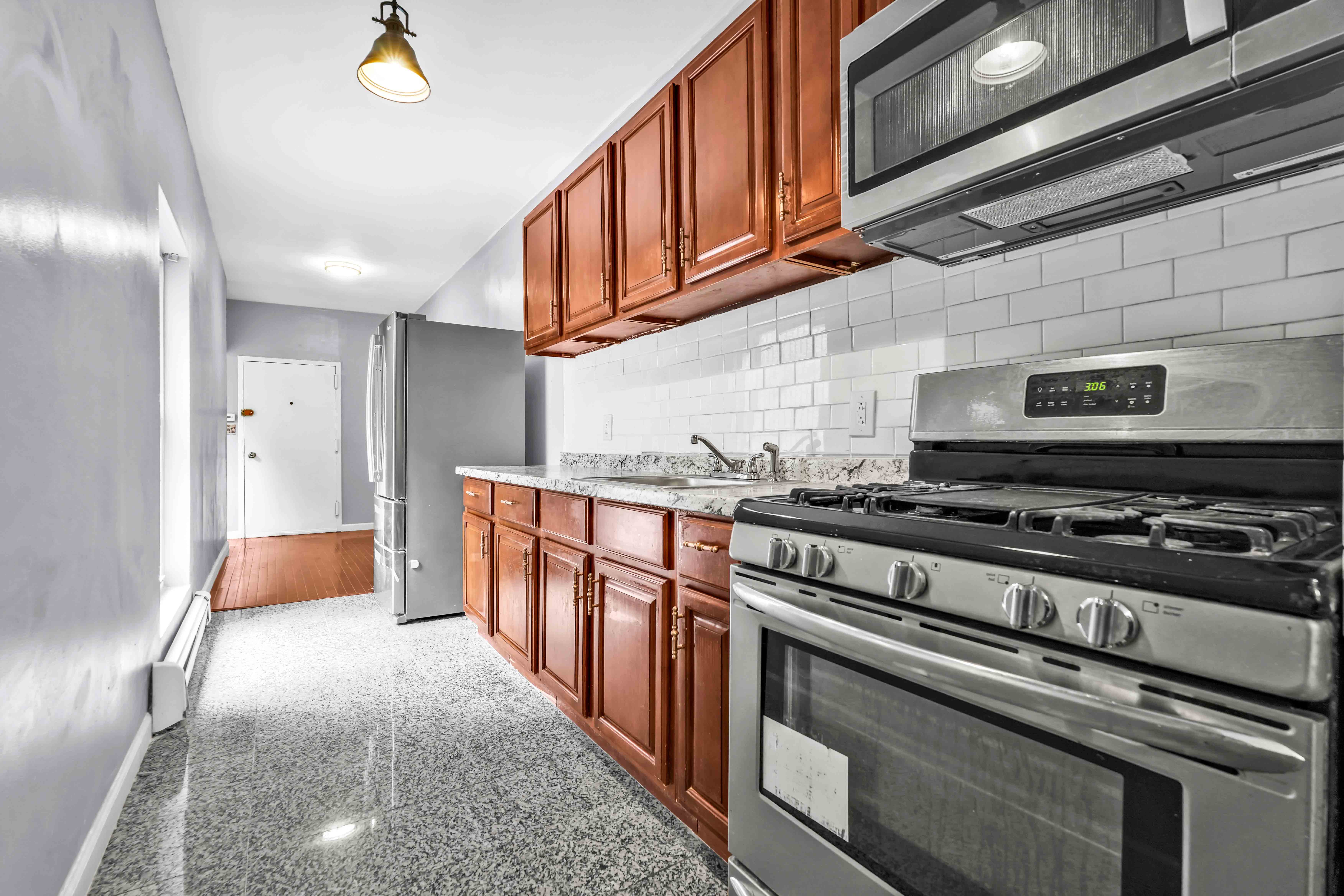 1633 St Johns Place, Unit 3 Brooklyn, NY 11233 - Photo 19 of 29 a kitchen with stainless steel appliances granite countertop a stove and a sink