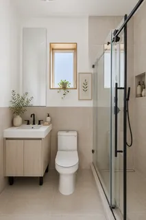 a bathroom with a toilet a sink and shower