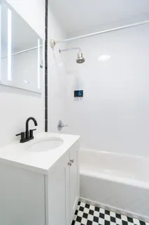a bathroom with a sink a mirror and a bathtub