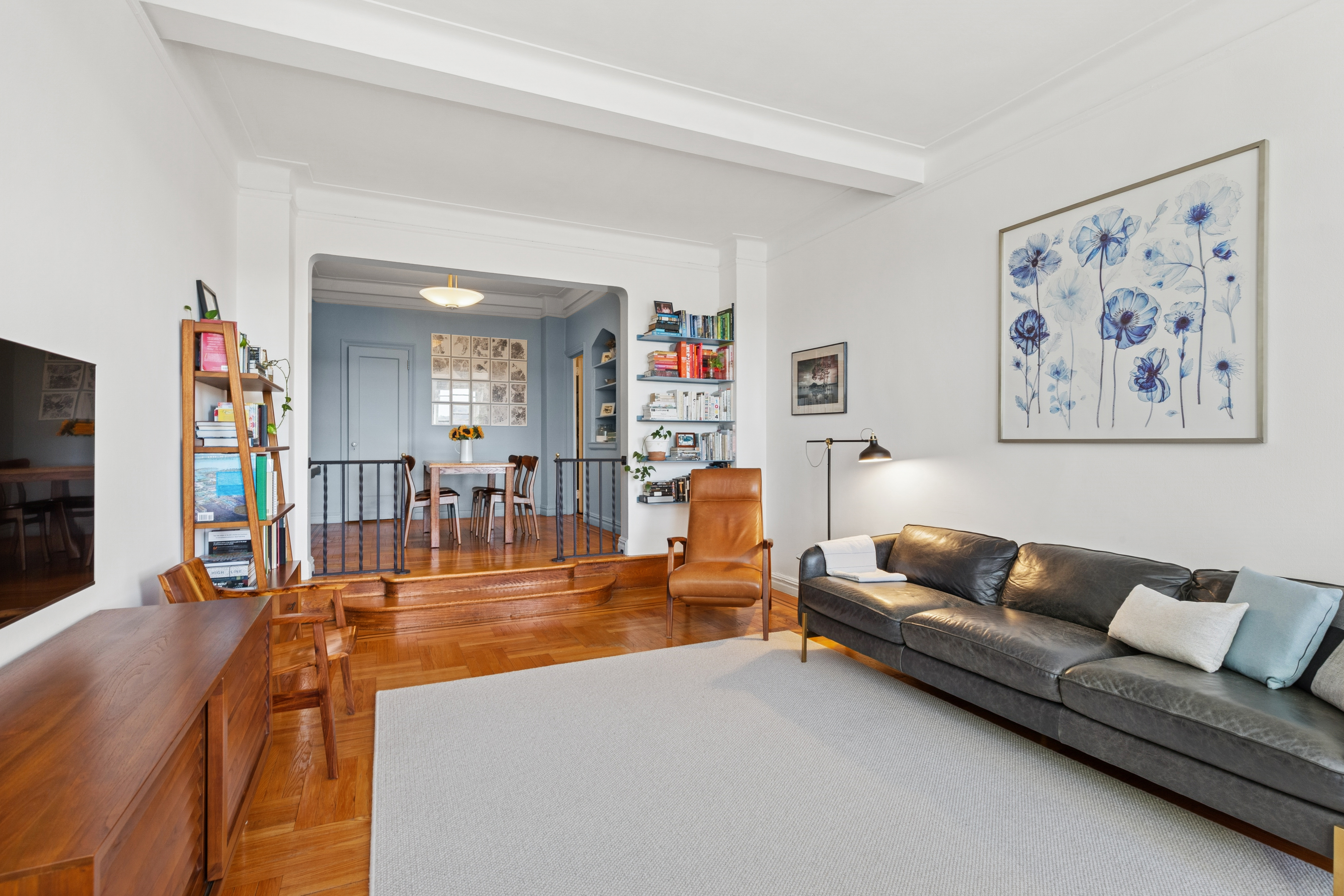 250 Cabrini Boulevard, Unit 1H Manhattan, NY 10033 - Photo 3 of 17 a living room with furniture and a flat screen tv