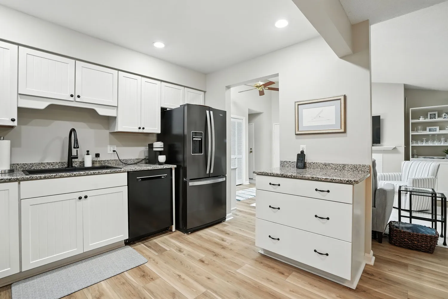 a kitchen with granite countertop cabinets and refrigerator