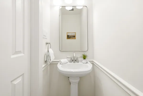 a bedroom with a bed and dresser with mirror