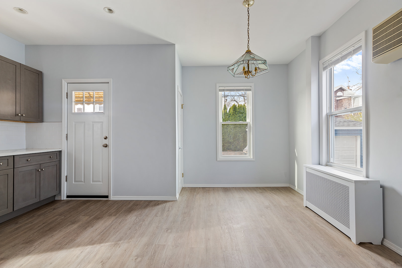 96 86th Street Brooklyn, NY 11209 - Photo 5 of 13 a view of an empty room with a window and wooden floor