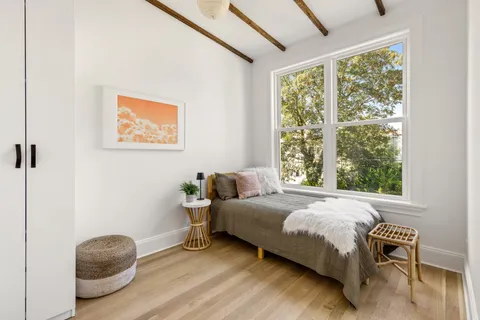 a bedroom with a bed and a chair