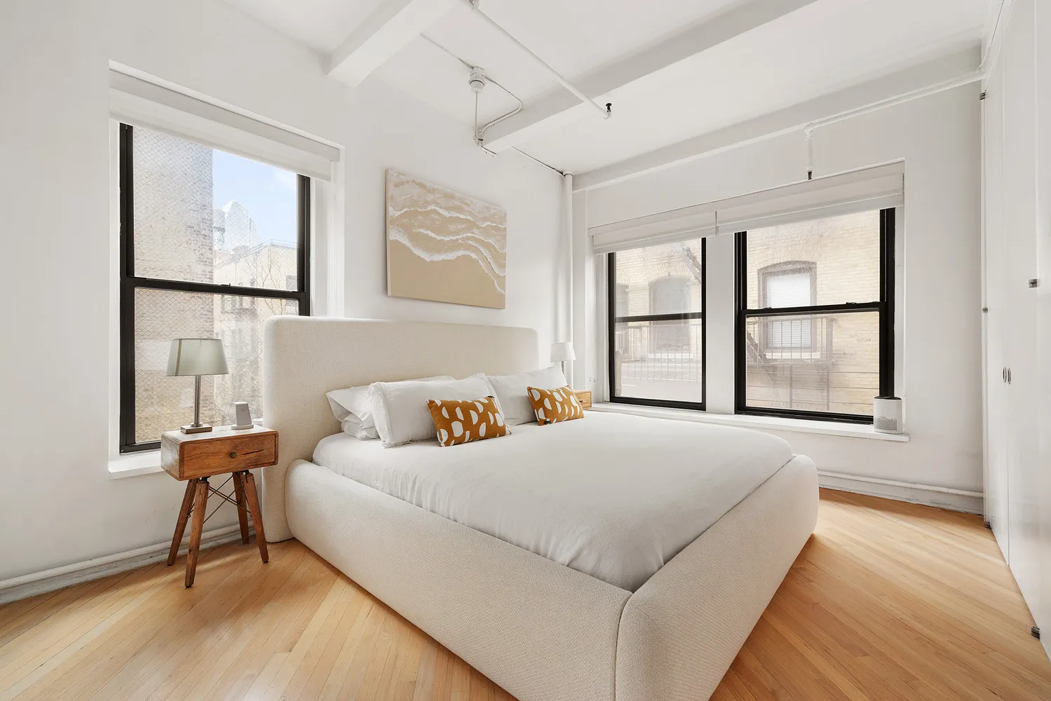 a bedroom with a bed and a large window