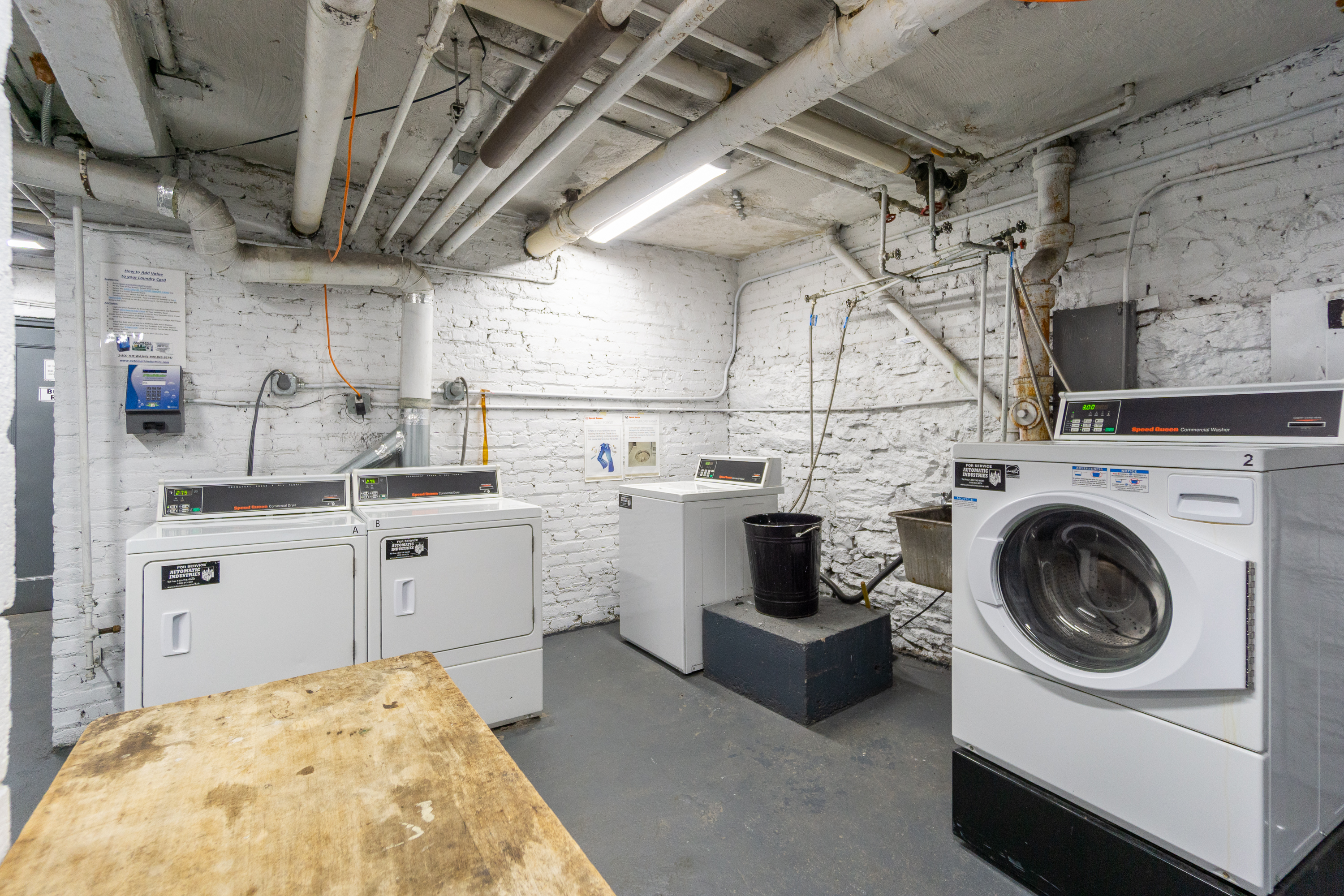 315 East 5th Street, Unit 5E Manhattan, NY 10003 - Photo 10 of 11 a utility room with cabinets dryer and washer