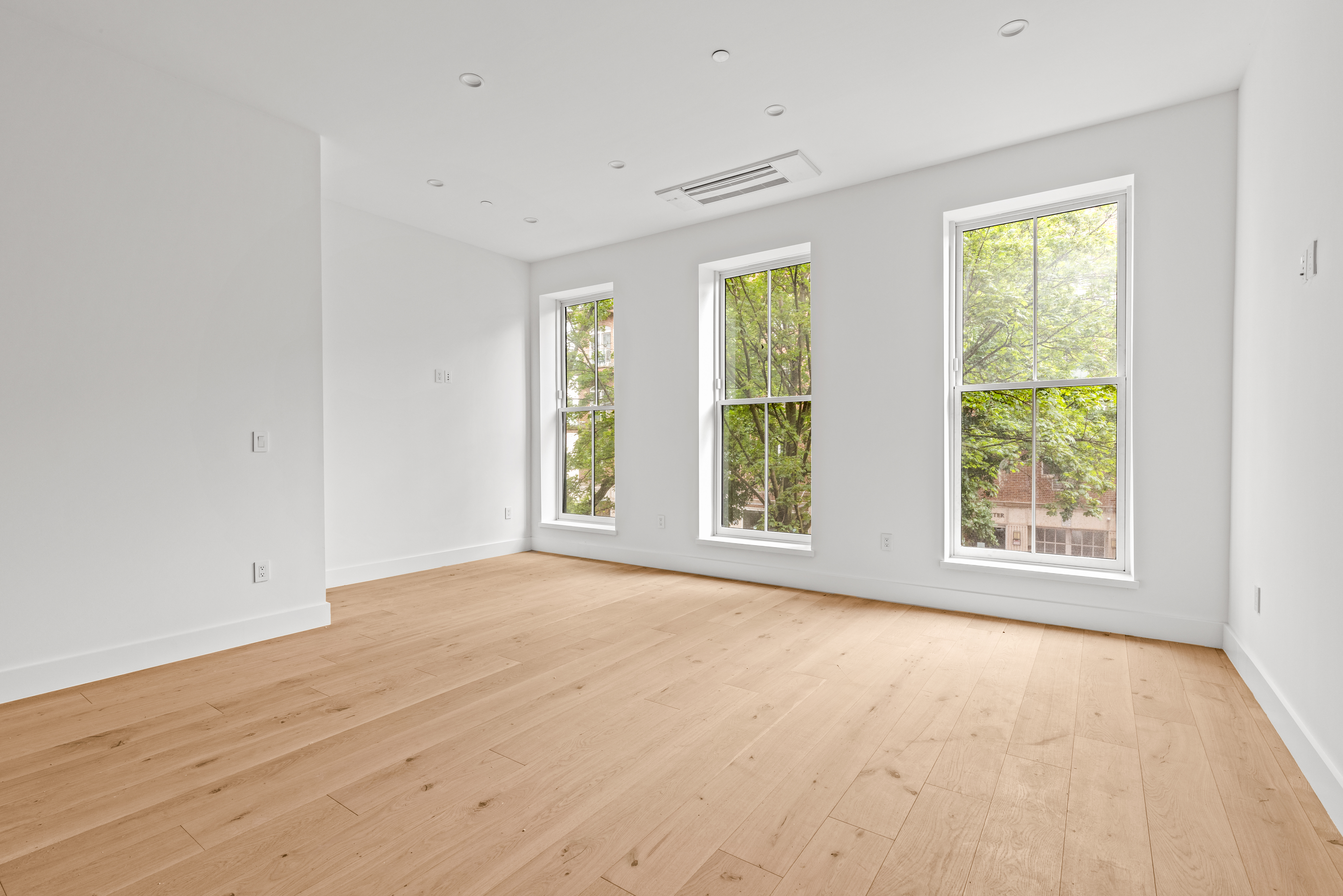 74 Carroll Street, Unit 2 Brooklyn, NY 11231 - Photo 2 of 13 a view of an empty room with wooden floor and a window