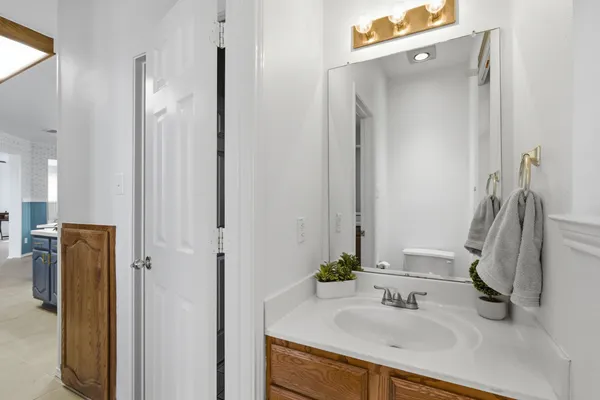 a bathroom with a sink vanity and a mirror