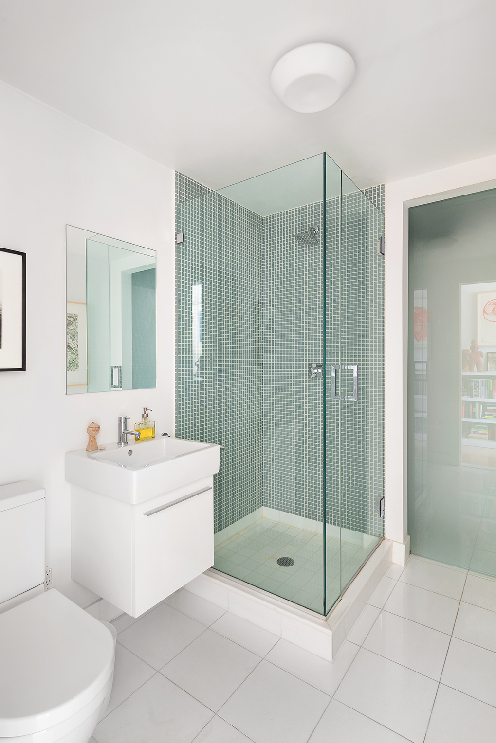 366 Broadway, Unit 8A Manhattan, NY 10013 - Photo 10 of 13 a bathroom with a sink mirror and a shower