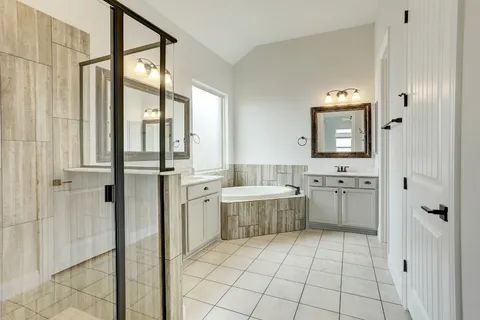 a bathroom with a granite countertop sink a toilet and shower