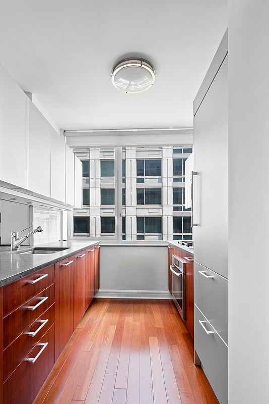 100 Riverside Boulevard, Unit 6C Manhattan, NY 10069 - Photo 4 of 6 a view of kitchen with wooden floor and electronic appliances