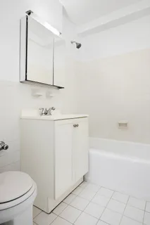 a bathroom with a sink a toilet and bathtub