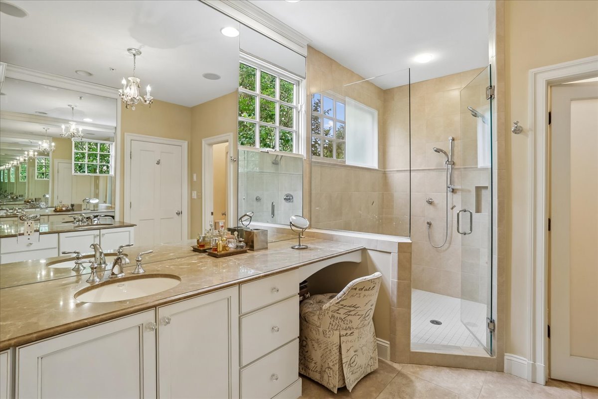11736 Gainsborough Road Potomac, MD 20854 - Photo 59 of 90 a bathroom with a granite countertop sink mirror and a shower