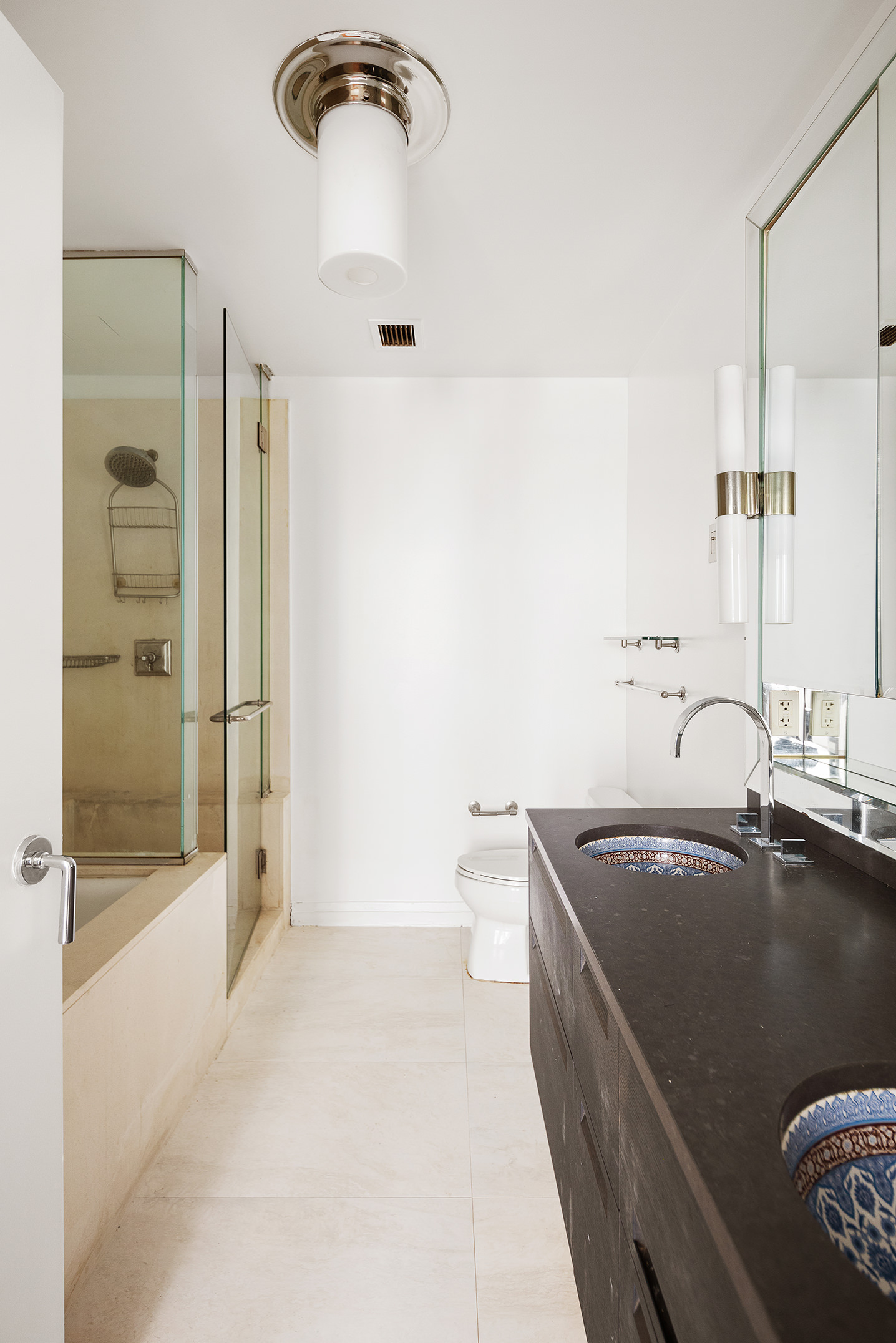 55 Wall Street, Unit 540 Manhattan, NY 10005 - Photo 5 of 10 a bathroom with a tub sink and mirror