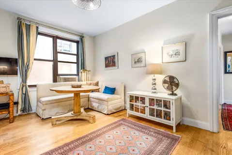 a bedroom with furniture and a window