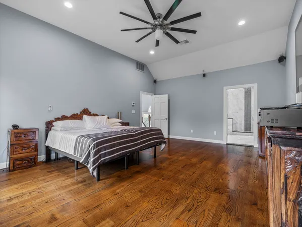 a bedroom with a bed and a ceiling fan