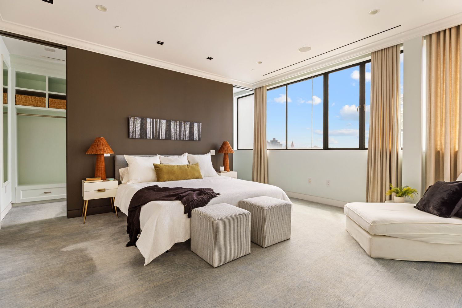 a bedroom with a bed and a large window