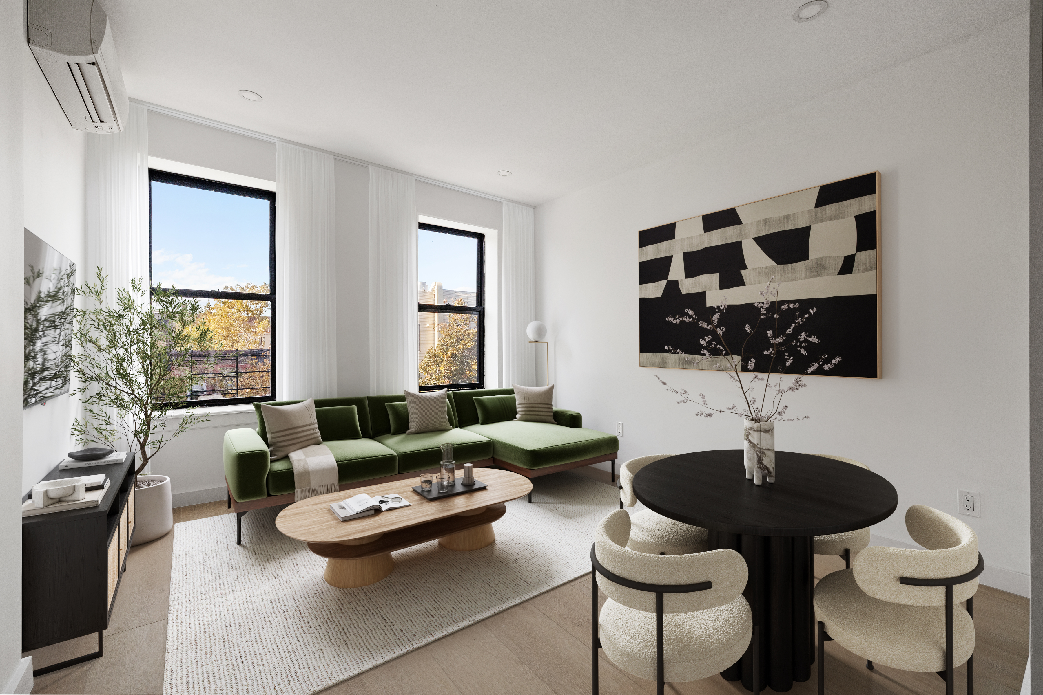 a living room with furniture and a potted plant