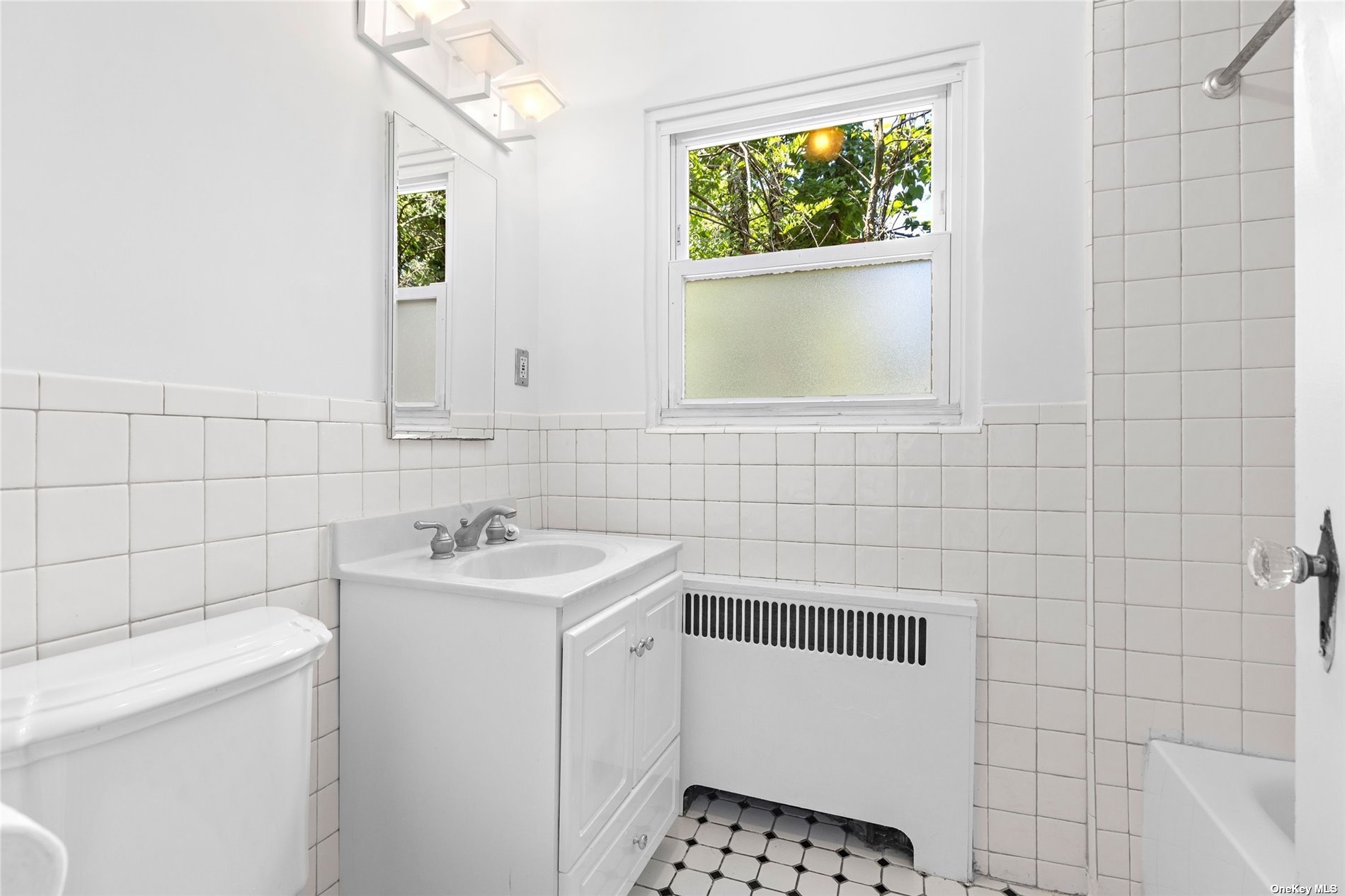 85-23 Edgerton Boulevard Queens, NY 11432 - Photo 20 of 36 a bathroom with a sink toilet and shower