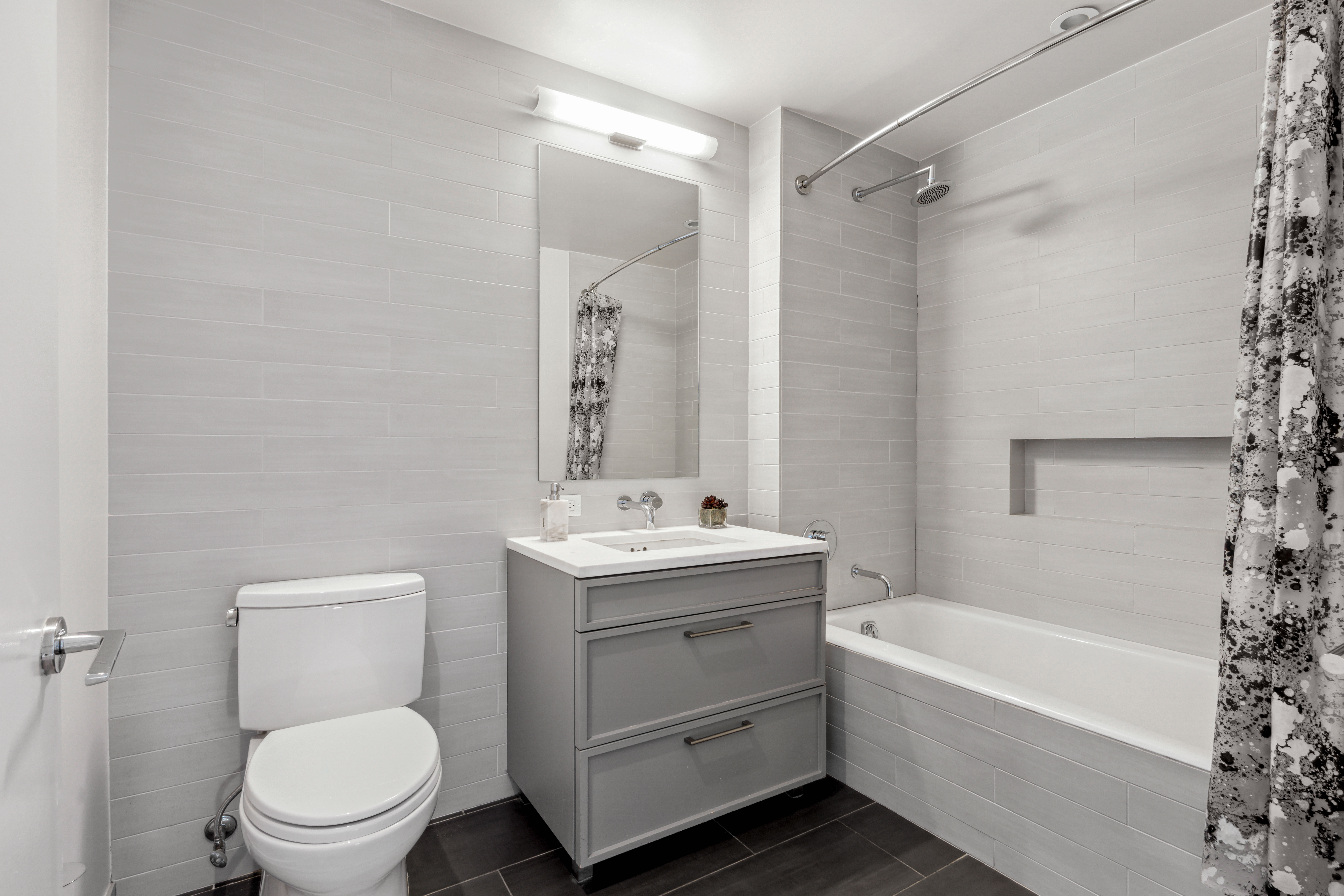 160 East 22nd Street, Unit 18C Manhattan, NY 10010 - Photo 10 of 12 a bathroom with a sink a toilet and shower