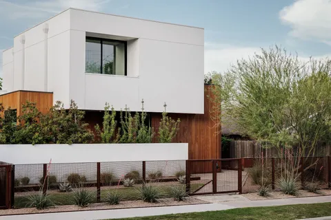 a view of house with yard and sitting area