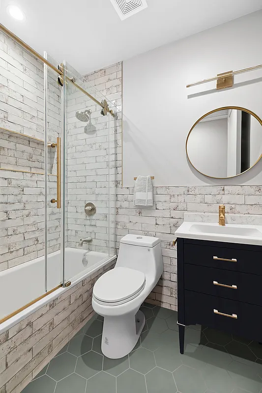 506 Woodward Avenue, Unit 1R Queens, NY 11385 - Photo 7 of 10 a bathroom with a sink toilet a mirror and shower