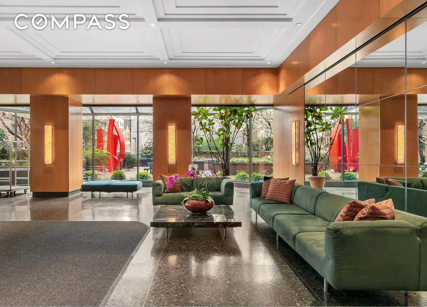 a living room with furniture and floor to ceiling windows