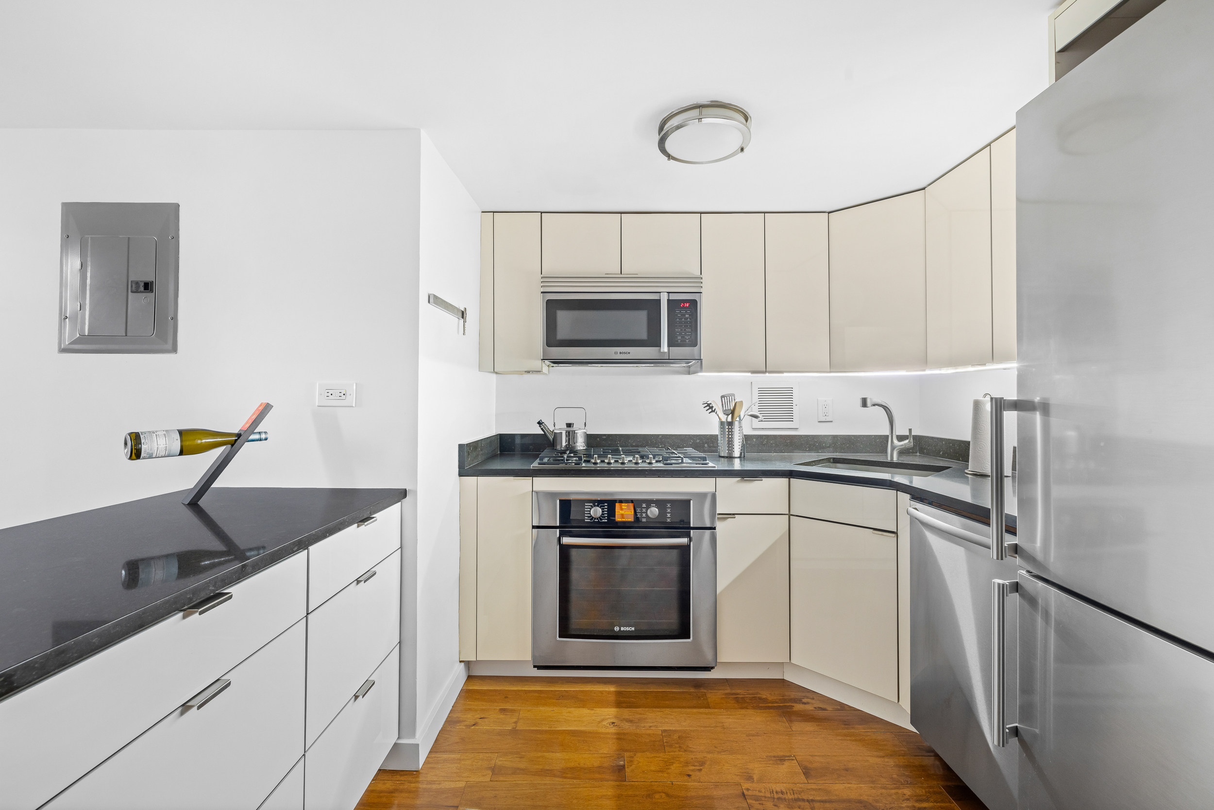 55 Poplar Street, Unit 6K Brooklyn, NY 11201 - Photo 6 of 15 a kitchen with stainless steel appliances granite countertop a sink stove and refrigerator