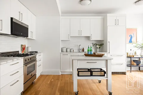 a kitchen with stainless steel appliances a stove a sink and a microwave