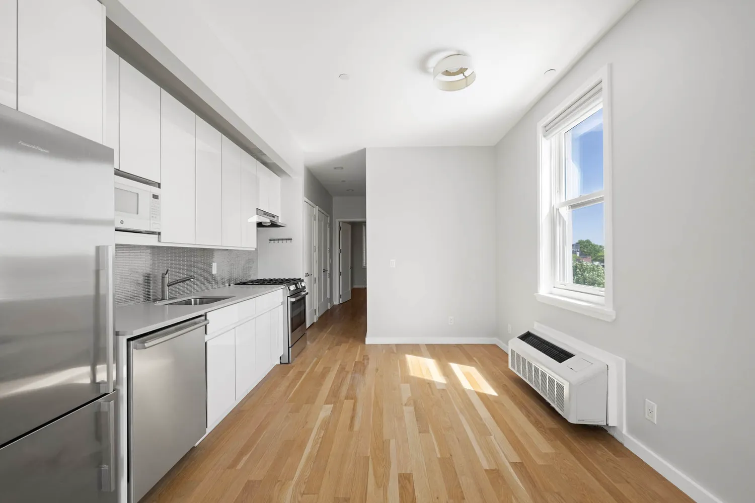 a kitchen with granite countertop white cabinets and stainless steel appliances