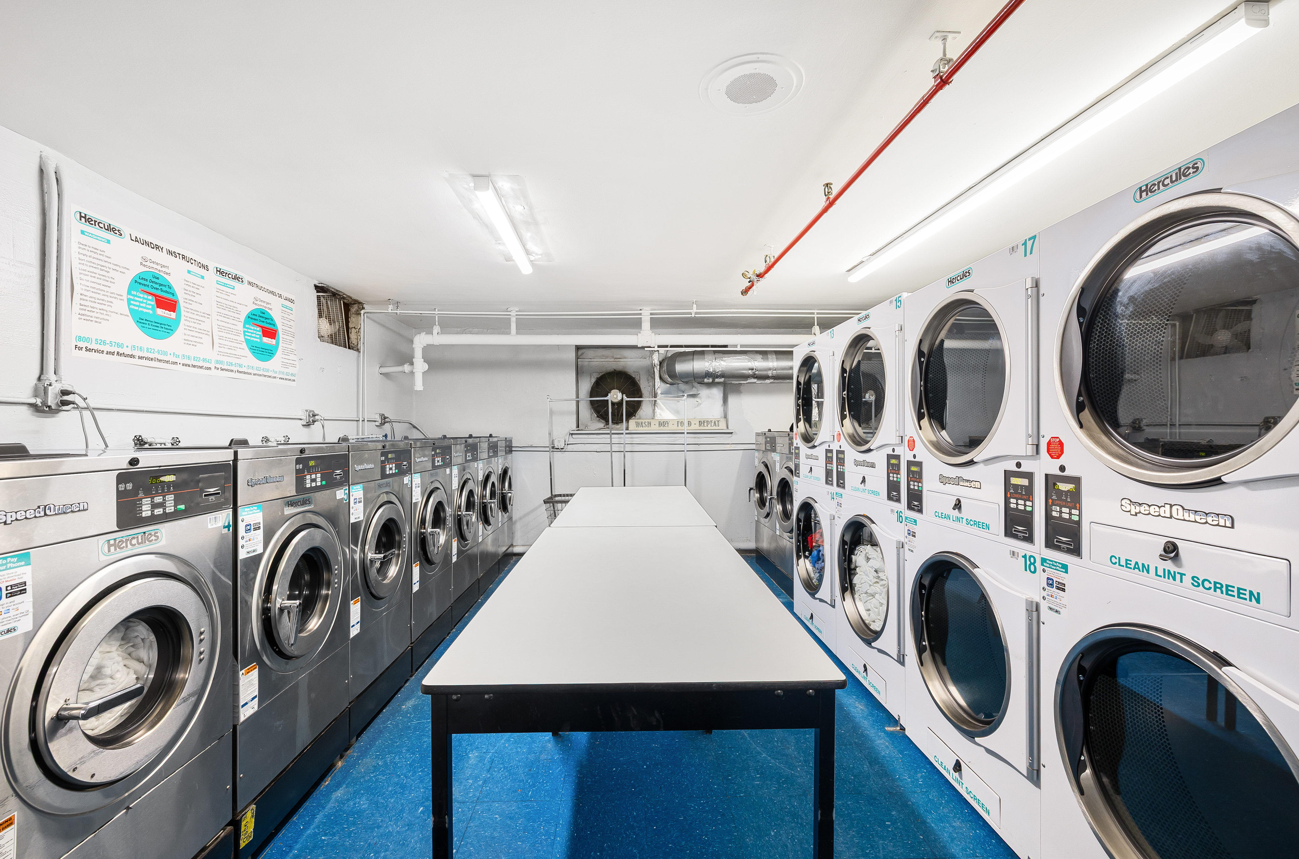 165 Christopher Street, Unit 5DD Manhattan, NY 10014 - Photo 12 of 15 a utility room with dryer washer and other items